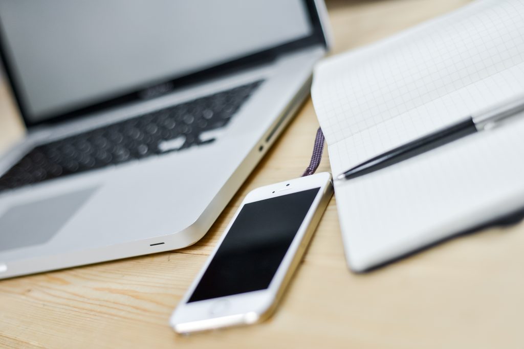 Business-Desk-With-Laptop-Smartphone-Book-And-Pen